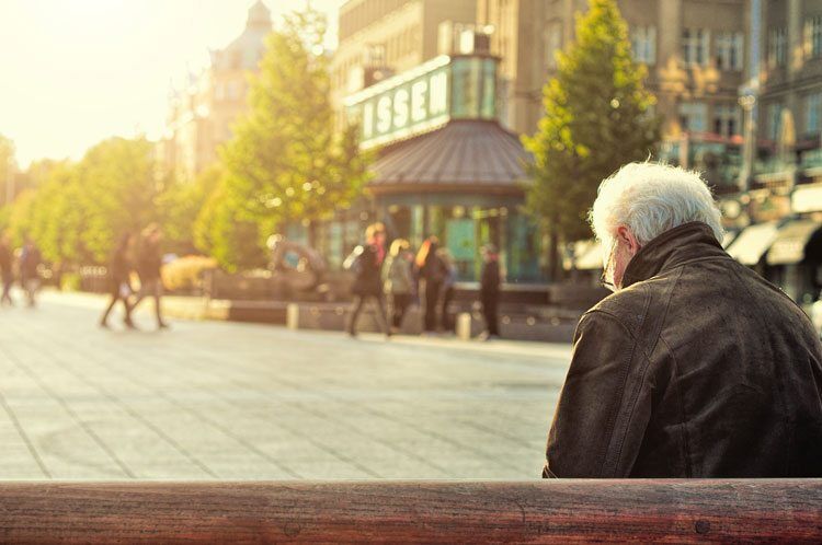 an old man sitting on a bench